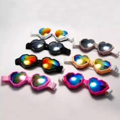 Heart-shaped LED sunglasses with vibrant, multi-color lenses and adjustable straps, suitable for parties, festivals, and celebrations. Durable, lightweight, and trending accessories that add fun and style to any event or outfit.