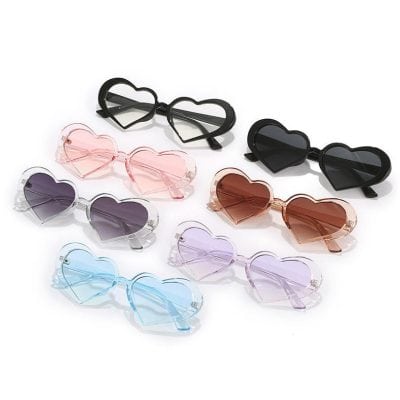 Heart-shaped sunglasses in various colors including black, pink, purple, blue, and brown, designed for women. Stylish, trendy, UV-protected eyewear suitable for fashion and sun protection.
