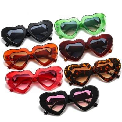 Vibrant heart-shaped sunglasses in multiple colors including black, green, red, tortoiseshell, and pink, perfect for stylish kids and teenagers. Durable and UV-protective eyewear ideal for outdoor use and fashion statements.