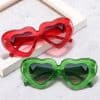 Vibrant red and green heart-shaped sunglasses with dark lenses, perfect for trendy fashion statements. Ideal accessories for enhancing your style and protecting your eyes.