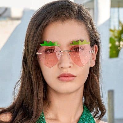 Fun pineapple-shaped sunglasses with pink lenses, perfect for summer and outdoor activities. Stylish accessory for fashion-forward individuals seeking a playful look.