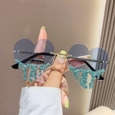 Elegant butterfly sunglasses with sparkly blue embellishments, perfect for fashion-forward eyewear lovers. Ideal for stylish occasions and sun protection.
