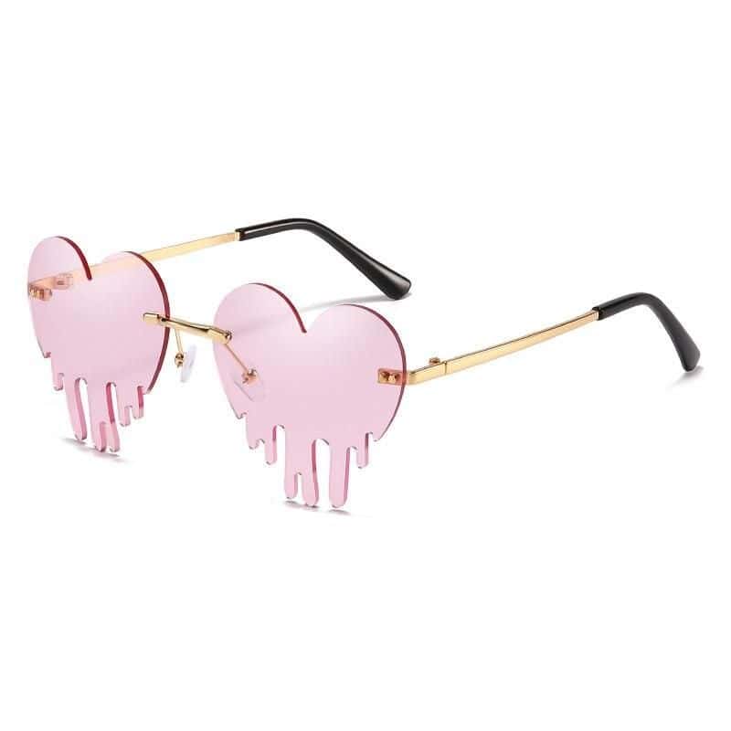 Fashionable heart-shaped sunglasses with pink dripping lenses and black arms, ideal for women seeking trendy accessories.