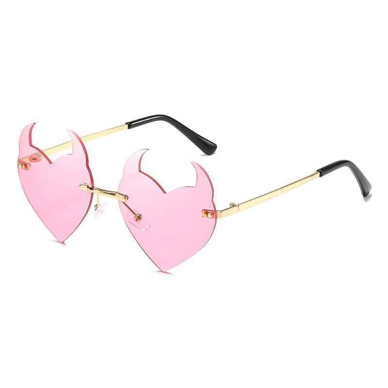 Stylish pink heart-shaped sunglasses with gold accents, ideal for fashionable women seeking trendy optical eyewear and summer accessories.