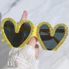 Stylish yellow rhinestone heart sunglasses with dark lenses, perfect for trendy fashion accessories and eye protection.