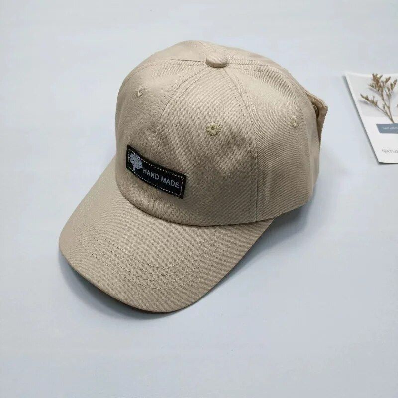 Stylish beige handmade cap with "Hand Made" patch, perfect for everyday wear and outdoor activities. Comfortable and trendy accessory for fashion-conscious individuals.