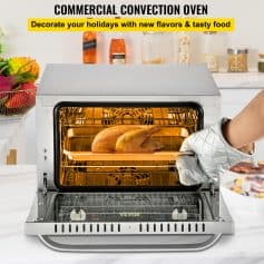 Indoor commercial convection oven with food-ready, whole chicken roasting inside, suitable for restaurants and catering kitchens.