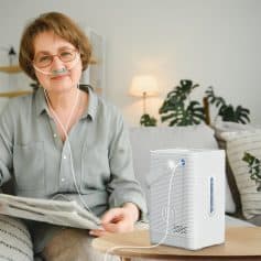 Portable oxygen therapy device in cozy living room setting, providing medical-grade oxygen support for respiratory health, ideal for home use and oxygen therapy needs.