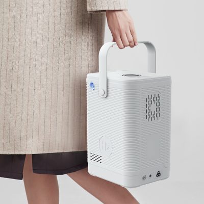 Image of a portable oxygen concentrator being carried by a person, highlighting easy mobility and breathing assistance. Compact design ideal for oxygen therapy patients needing reliable respiratory support.