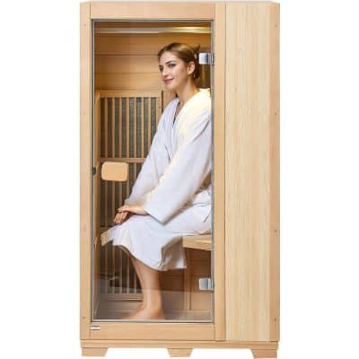 A woman wearing a white bathrobe sits comfortably inside a wooden infrared sauna cabin, promoting relaxation, detoxification, and improved circulation through innovative sauna therapy.