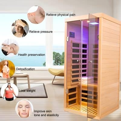 A wooden infrared sauna cabin with glass door inside a modern, bright room, promoting health benefits like pain relief and detoxification.