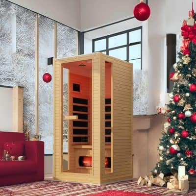 Luxurious wooden infrared sauna cabin in a cozy, modern interior with Christmas decorations, perfect for health benefits and stress relief at Monalisa Medical.