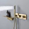 Luxurious gold shower system with modern controls, featuring a wall-mounted design and a built-in shelf for toiletries, perfect for elegant bathroom aesthetics.