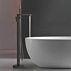 Elegant bathroom sink with black floor-mounted faucet, minimalist modern design, ideal for spa, vanity, or luxury home bathrooms, combining style and functionality.