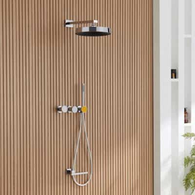High-quality chrome shower head with wall-mounted controls and handheld spray in a stylish bathroom for luxury bath experience.