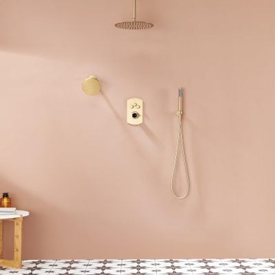 Luxurious bathroom shower with pink walls, gold shower fixtures, rainfall overhead, and handheld sprayer, complemented by stylish patterned floor tiles. Ideal for bathroom renovations, spa-like ambiance, and upscale bath designs.