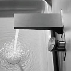 Stainless steel water tap with adjustable knob in a professional setting, ideal for laboratories, medical facilities, or commercial kitchens, emphasizing durability and hygiene.