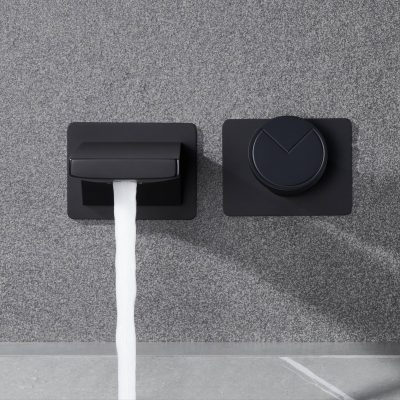 A sleek black toilet paper dispenser and flush button mounted on a gray textured wall, showcasing modern bathroom design suitable for optical and medical centers focusing on hygiene and patient comfort.