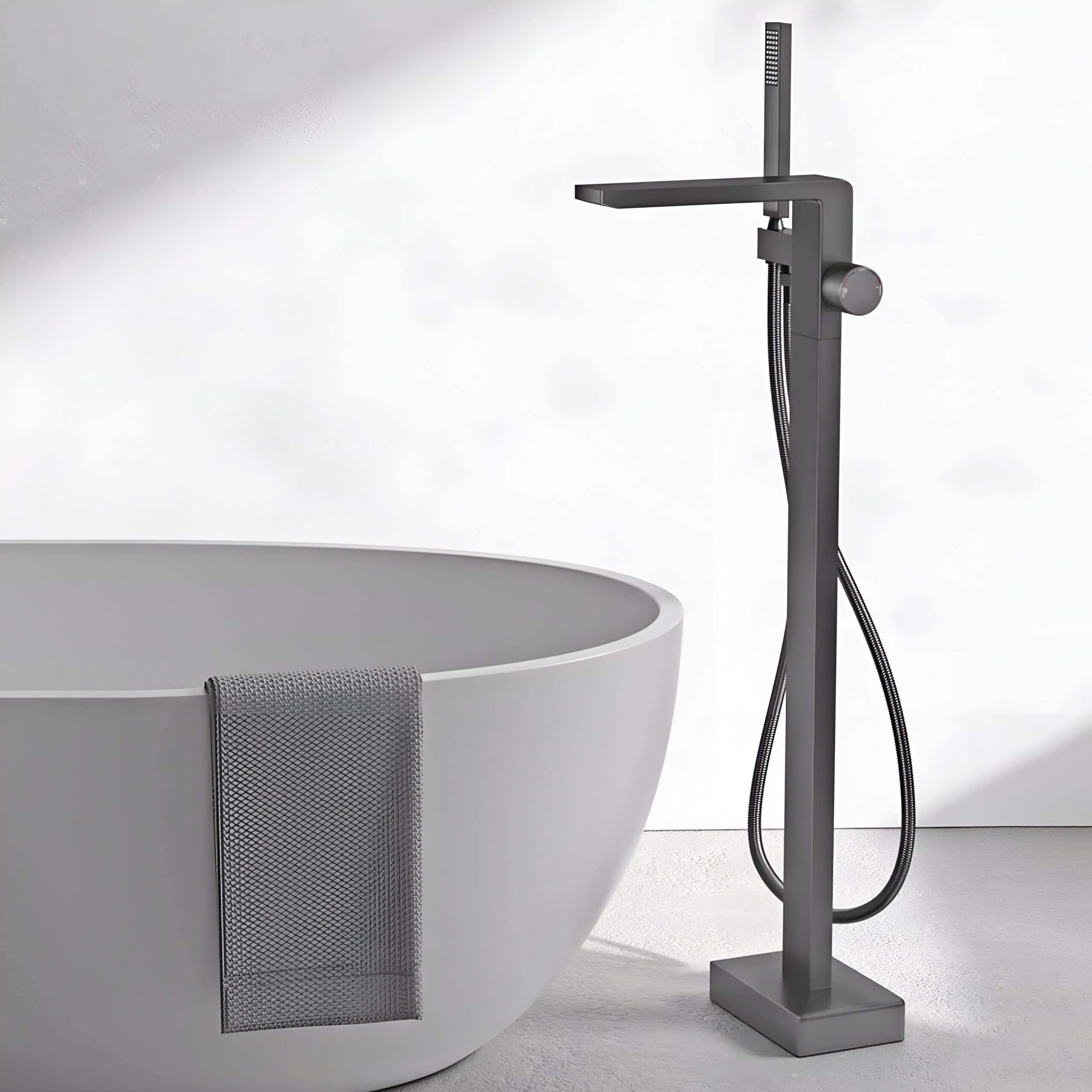 Bathroom tub with black floor-mounted faucet and hose, contemporary design, minimalist aesthetic, perfect for luxury spa, home bath update, elegant and functional decor, premium fixtures.