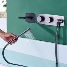 A sleek, wall-mounted water faucet with integrated handheld shower head, perfect for medical or salon use, offering adjustable temperature controls and easy operation.