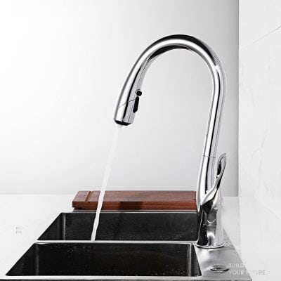 A contemporary chrome kitchen faucet dispensing water over a double sink, emphasizing quality and style. Perfect for modern home kitchens, combining functionality with elegant design.