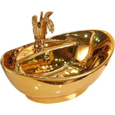Luxurious gold-colored sink featuring a detailed eagle figure on the faucet, ideal for upscale and decorative interior design.