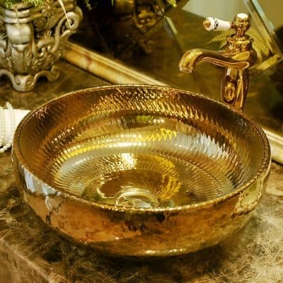 Elegant golden basin with textured finish for opulent bathroom decor. Perfect for high-end interiors, showcasing craftsmanship and timeless style.