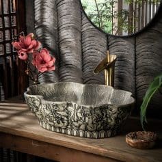 Luxurious Stone Bathtub with floral carvings in a spa-inspired setting.