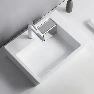 Sleek white bathroom sink with chrome faucet, ideal for modern bathrooms. Features a minimalist design, durable ceramic material, and easy-to-clean surface perfect for home or commercial use.