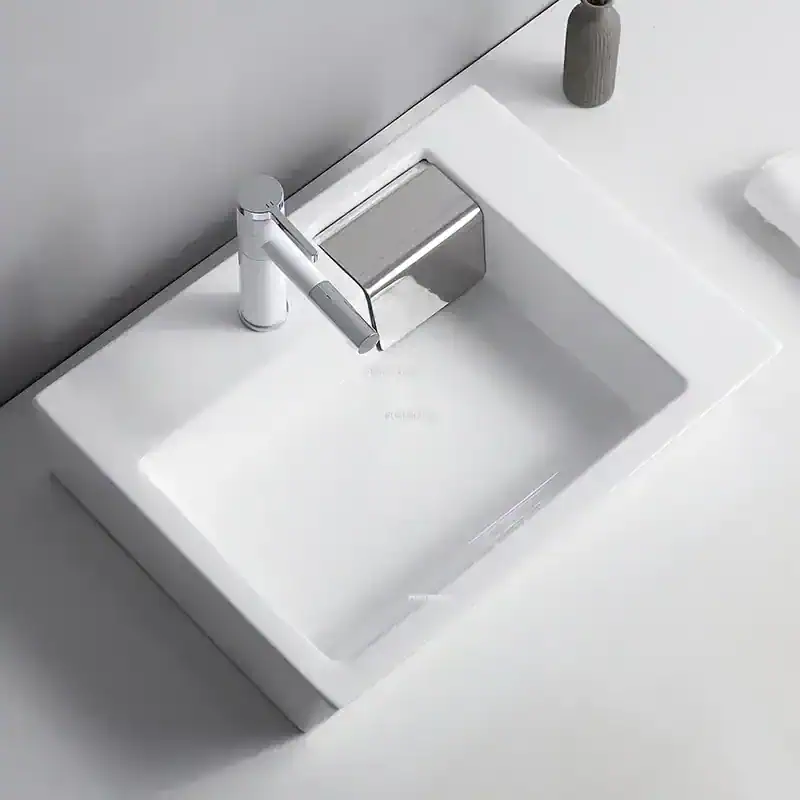Sleek white bathroom sink with chrome faucet, ideal for modern bathrooms. Features a minimalist design, durable ceramic material, and easy-to-clean surface perfect for home or commercial use.