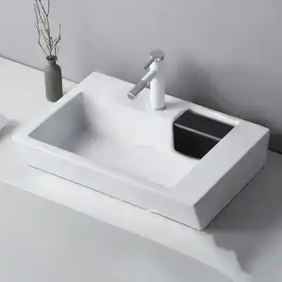 Elegant white bathroom vanity featuring a modern sink, chrome faucet, and black soap dish, perfect for upscale home or commercial bathroom designs.