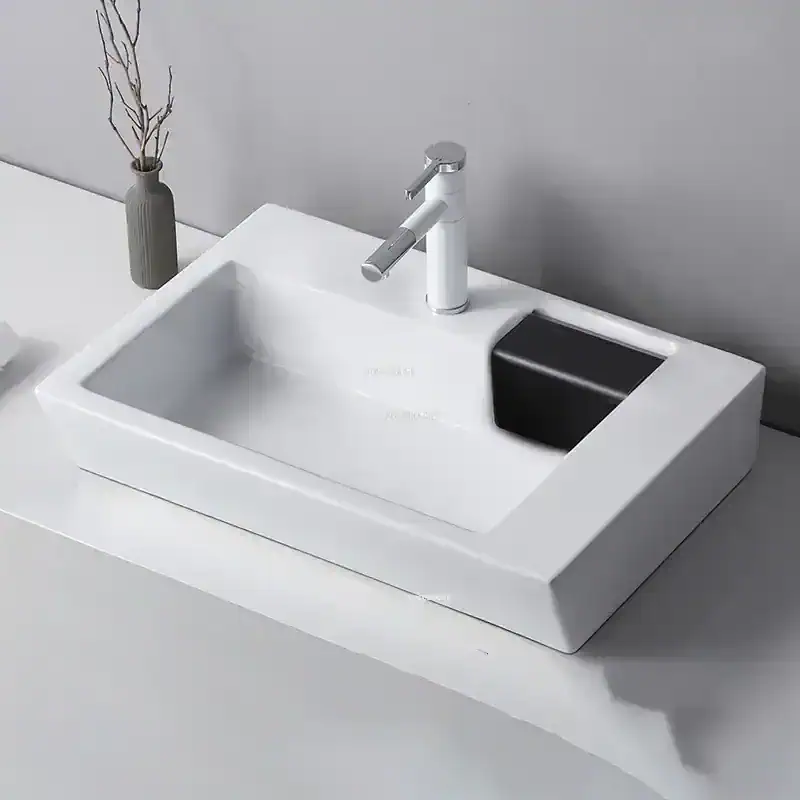 Elegant white bathroom vanity featuring a modern sink, chrome faucet, and black soap dish, perfect for upscale home or commercial bathroom designs.