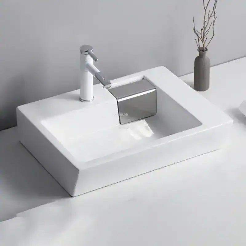 Clean and sleek white bathroom sink with chrome faucet, perfect for modern bathroom decor and functional daily use.