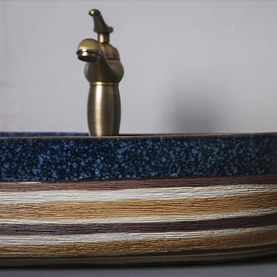 Brass faucet above layered wooden countertop, ideal for stylish bathrooms and high-end home interiors.