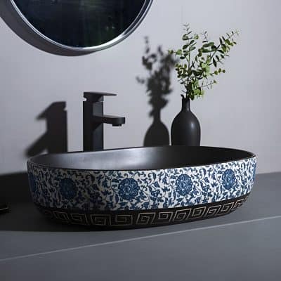 Elegant ceramic bathroom sink featuring a blue floral design and Greek key border, perfect for enhancing bathroom aesthetics and functionality.