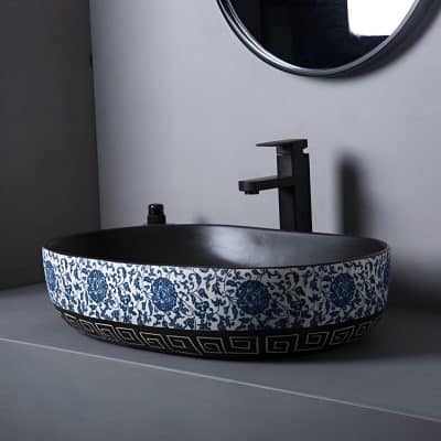 Beautiful ceramic bathroom sink featuring intricate blue floral patterns with a sleek black faucet, perfect for enhancing bathroom aesthetics and offering functional elegance.