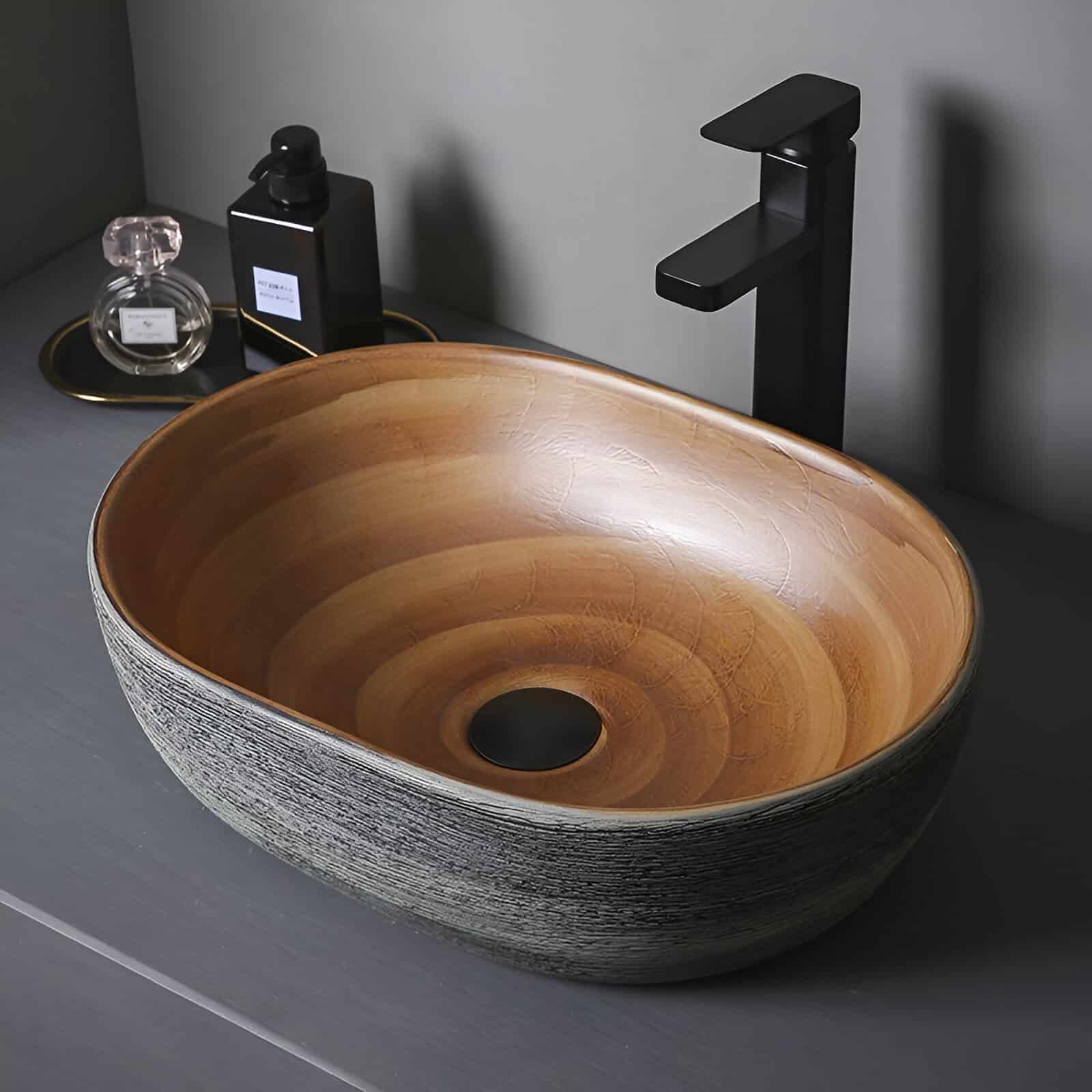 Luxurious oval wooden basin with contemporary black faucet, perfect for modern bathrooms seeking sophistication and functional design.