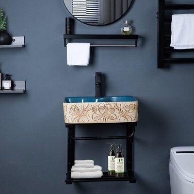 Luxurious bathroom sink with floral design, sleek black shelving, towels and skincare products, creating a sophisticated and hygienic setting ideal for opt clinics and wellness centers.