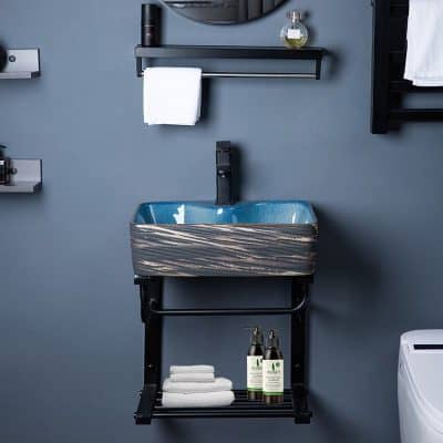 Elegant bathroom washstand with textured sink, toiletries, and towels for stylish home or spa decor.
