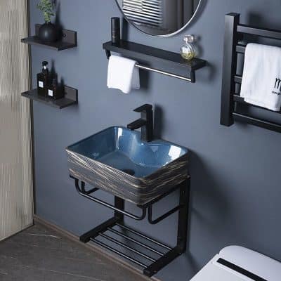 Elegant black shelf and towel rack with small accessories surrounding a sleek blue ceramic basin.