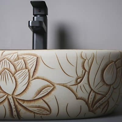 An intricately carved optical frame with floral patterns, showcasing craftsmanship and style in eyewear design. Perfect for opticians and eyewear boutiques.