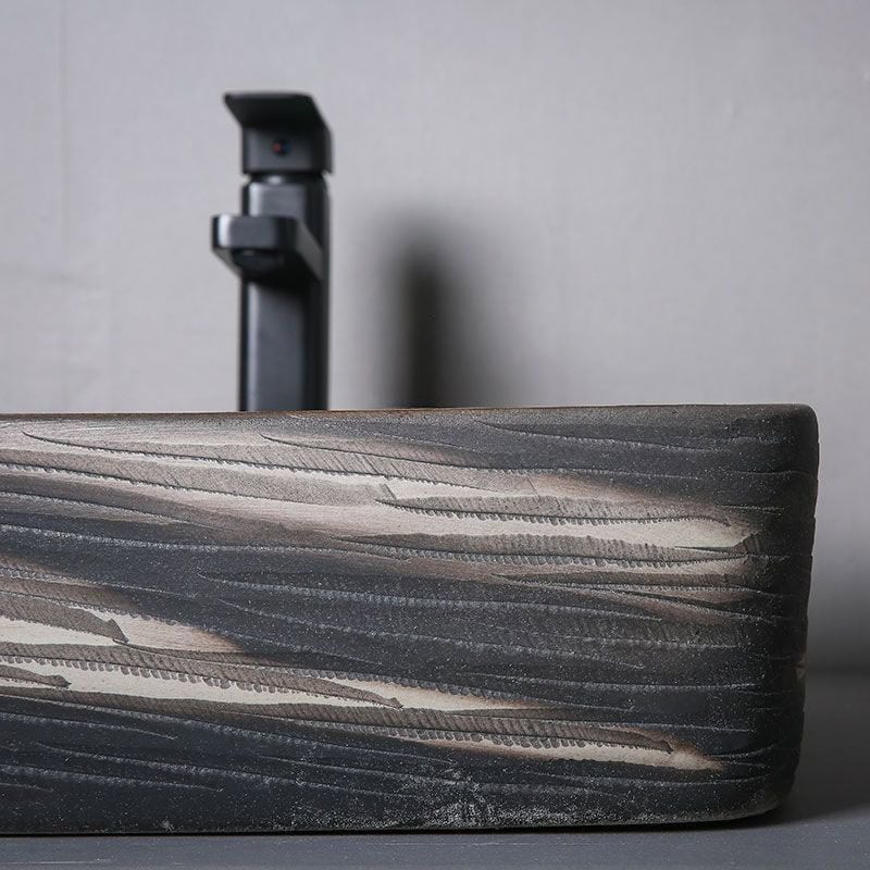 Elegant modern black faucet installed in a sleek concrete countertop, ideal for medical or professional settings, highlighting contemporary design and durability.