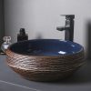 Modern black and brown ceramic vessel sink with textured exterior and glossy interior, ideal for stylish and functional bathroom decor.