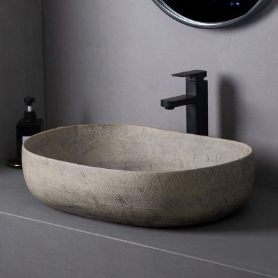 Elegant modern stone bathroom sink with sleek black faucet and minimalist design. Perfect for stylish, contemporary bathroom decor.