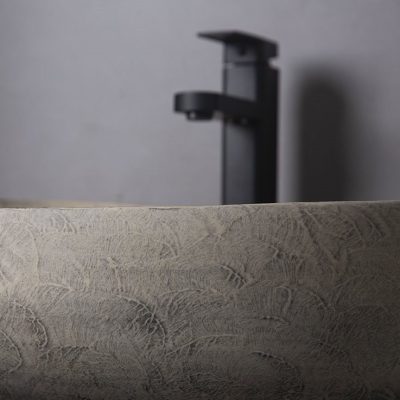 Modern black bathroom faucet above textured sink, minimalist design for contemporary bathrooms, high-quality fixtures, Monalisa Medical store.