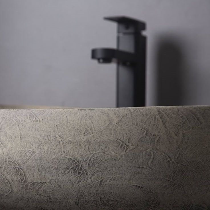 Modern black bathroom faucet above textured sink, minimalist design for contemporary bathrooms, high-quality fixtures, Monalisa Medical store.