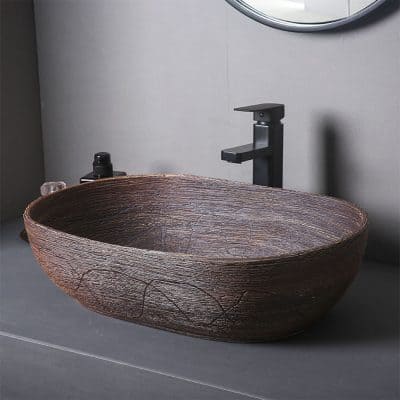 Handcrafted wooden vessel sink with natural texture and modern black faucet for stylish bathroom decor. Perfect for luxury and contemporary interior design.