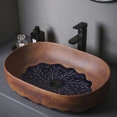 Luxury stone bathroom vessel sink with black and brown design, modern black faucet, and elegant bathroom accessories, perfect for upscale bathroom decor.