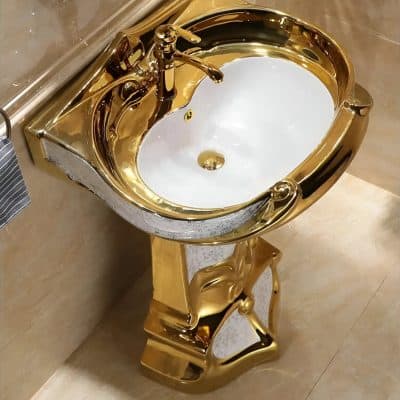 A sophisticated gold-colored sink with a sleek, shiny finish and ornate carved details, perfect for upscale bathrooms or salons focused on luxury and aesthetics.