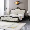 Elegant king-sized bed with ornate black and gold detailing, plush tufted upholstery, perfect for luxury bedroom decor.